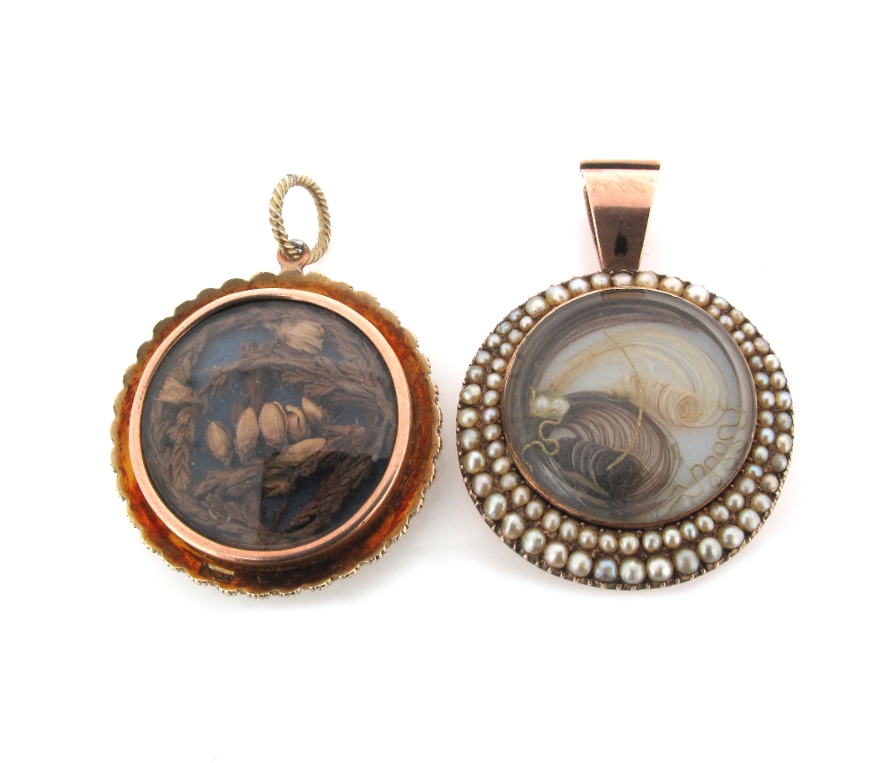 A late George III locket pendant, circular glazed centre piece containing hair and within two