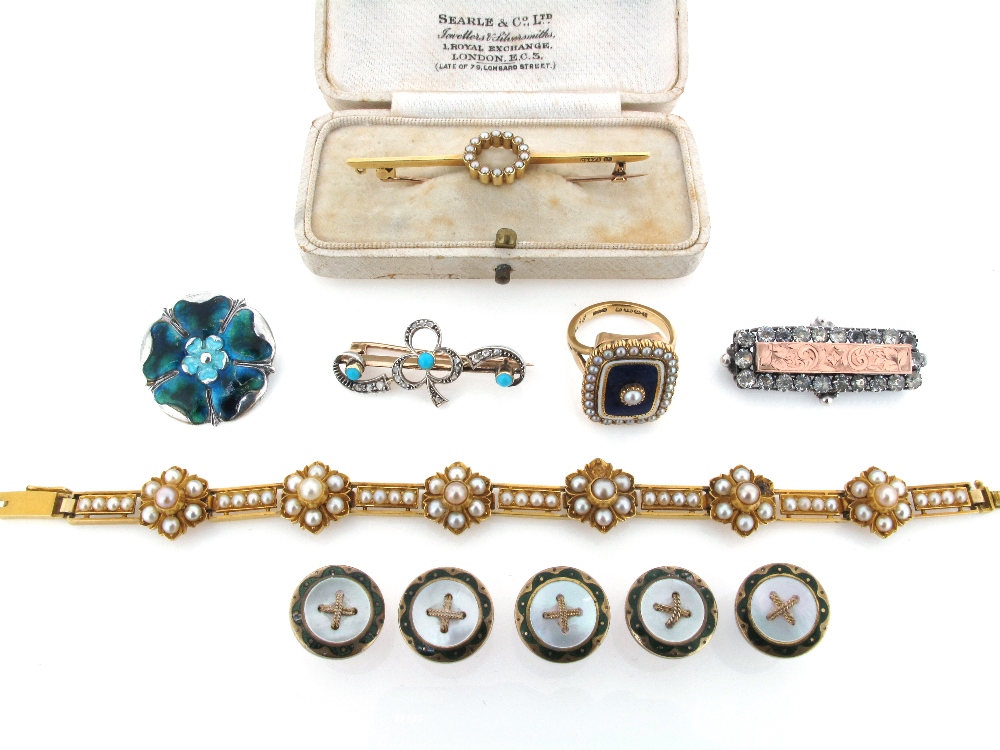 An early 20th Century gold bracelet, applied with six flower head panels set with pearls and joined