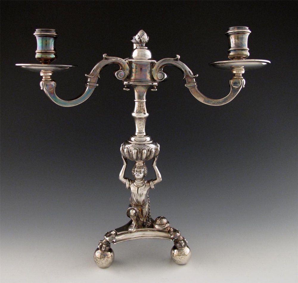 A Queen Anne silver candelabrum, by Anthony Nelme, London 1710, the column modelled as a kneeling
