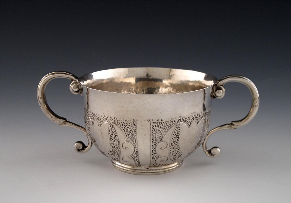 A late 17th century silver two-handled porringer, maker`s mark of T.C in a circle with a pelleted