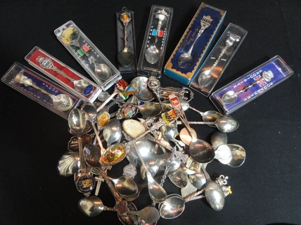 A large selection of silver plated and enamel souvenir spoons