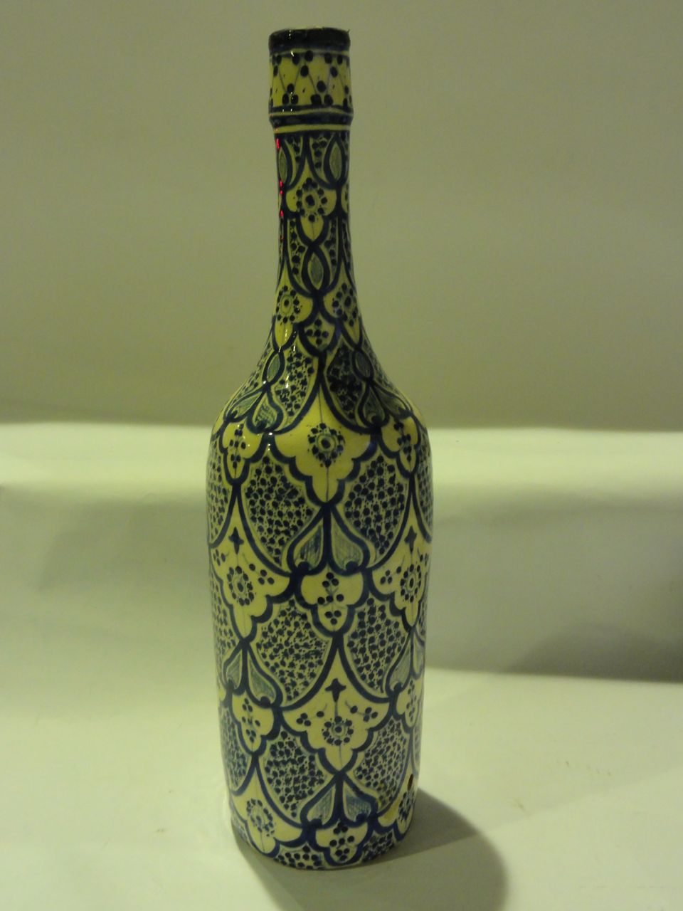 A large terracotta bottle vase with blue and white decoration with signature to base