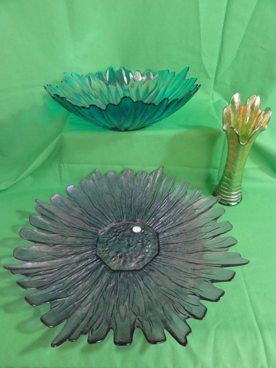 A large amethyst tinted glass dish in the form of an open flower constructed from recycled glass