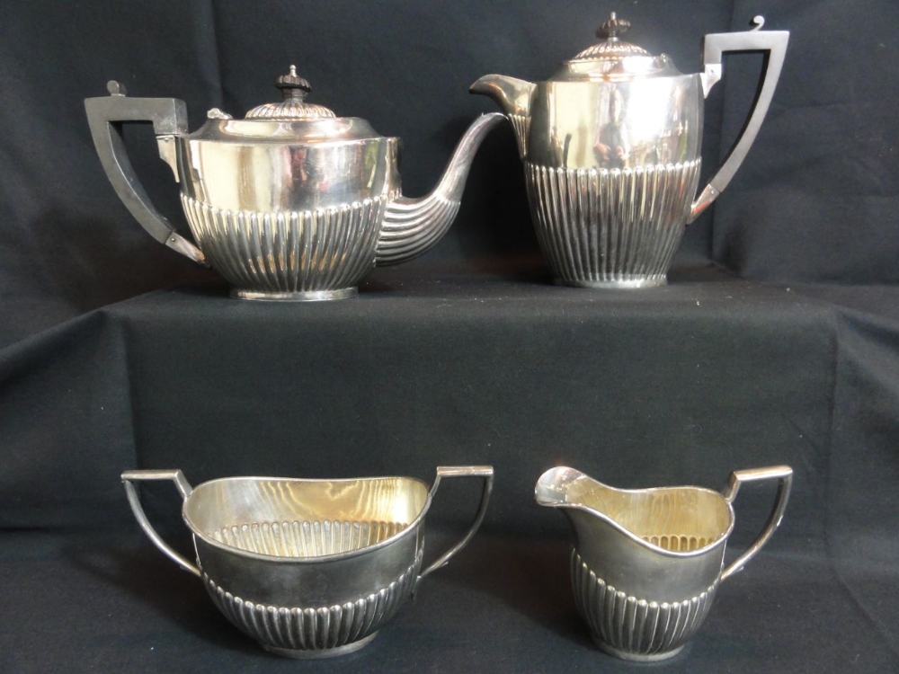 An early 20th century four piece silver plated tea set with half fluted decoration including teapot,