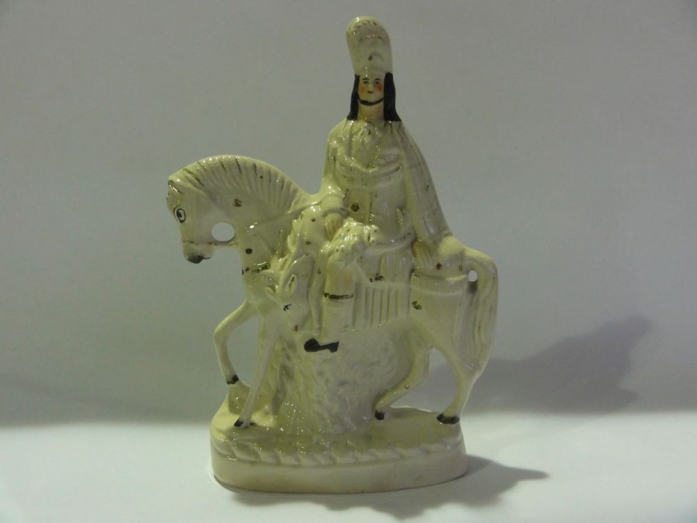 A 19th century Staffordshire earthenware group of a horse rider, 37 cm high approx