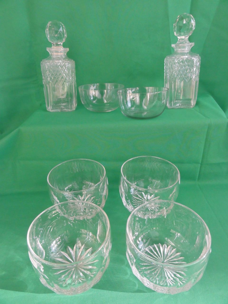 A pair of square form cut glass decanters with faceted globular stoppers, 23cm high approx