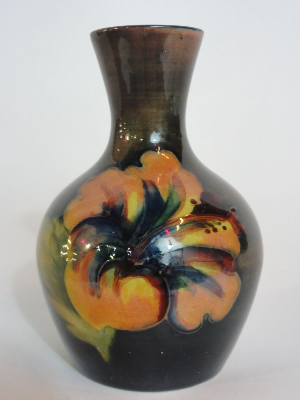 A Moorcroft flambe hibiscus bottle vase with flared neck, 9cm high approx