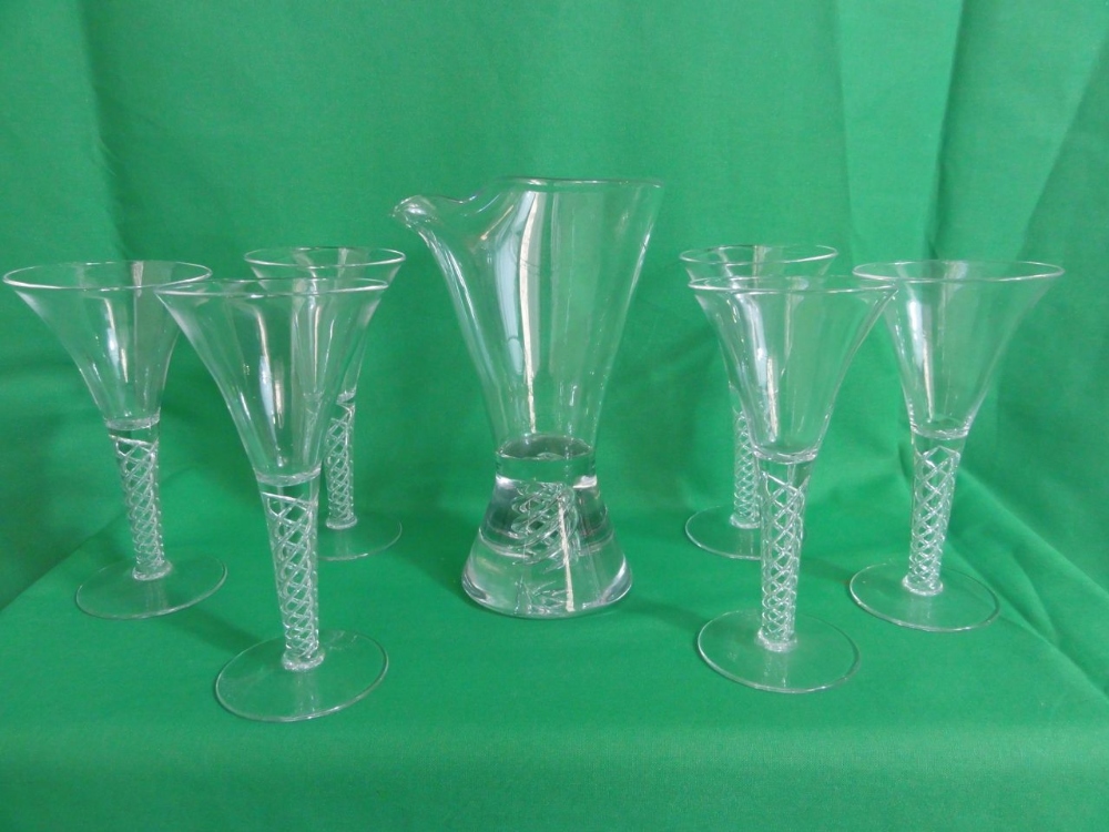 Six trumpet shaped glasses in the Georgian style with air twist stems together with similar spirit