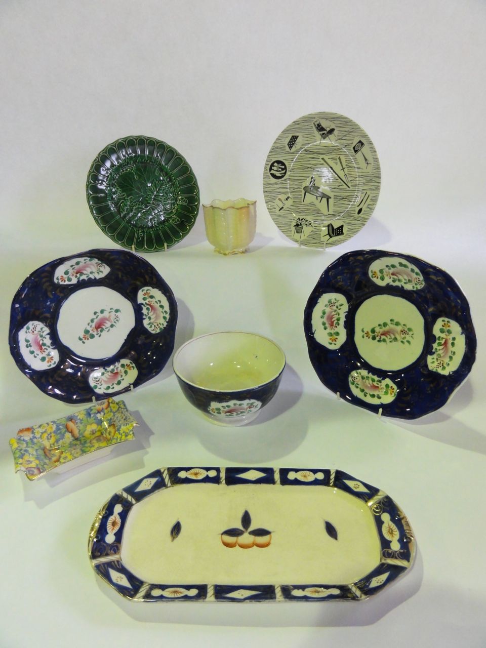 A gaudy Welsh slop bowl, two bread plates and a sandwich dish, a green majolica cabbage plate, a