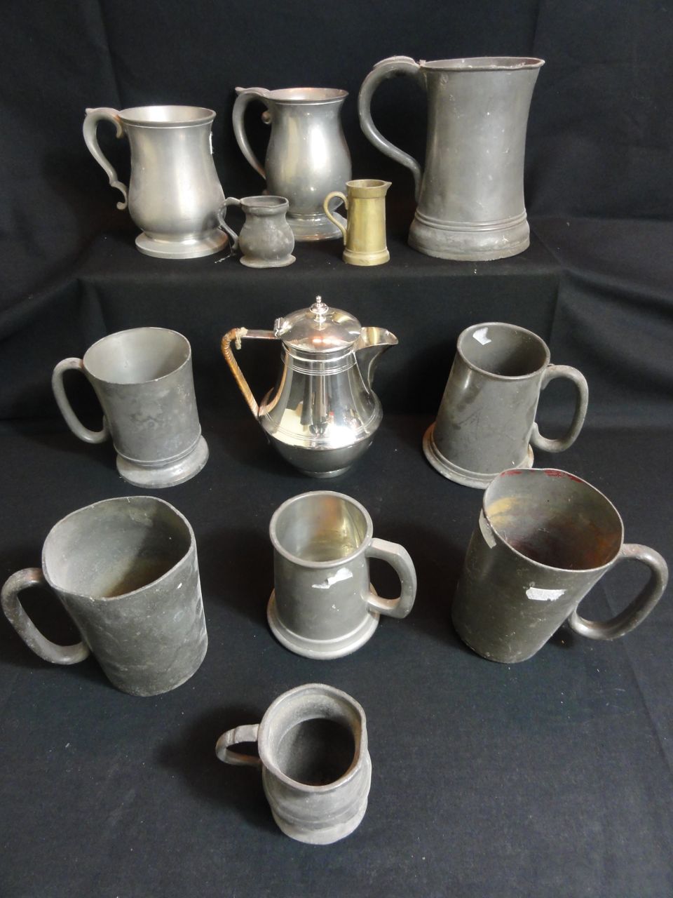 A selection of 19th century and later pewter mugs, gills and quart, a silver plated hot water jug