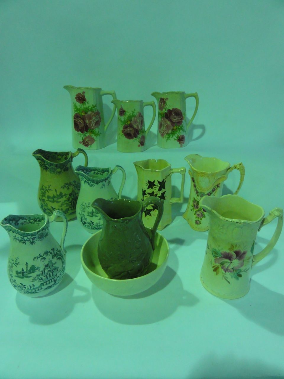 A selection of ten Victorian and later jugs including a graduated set of three Victorian jugs with