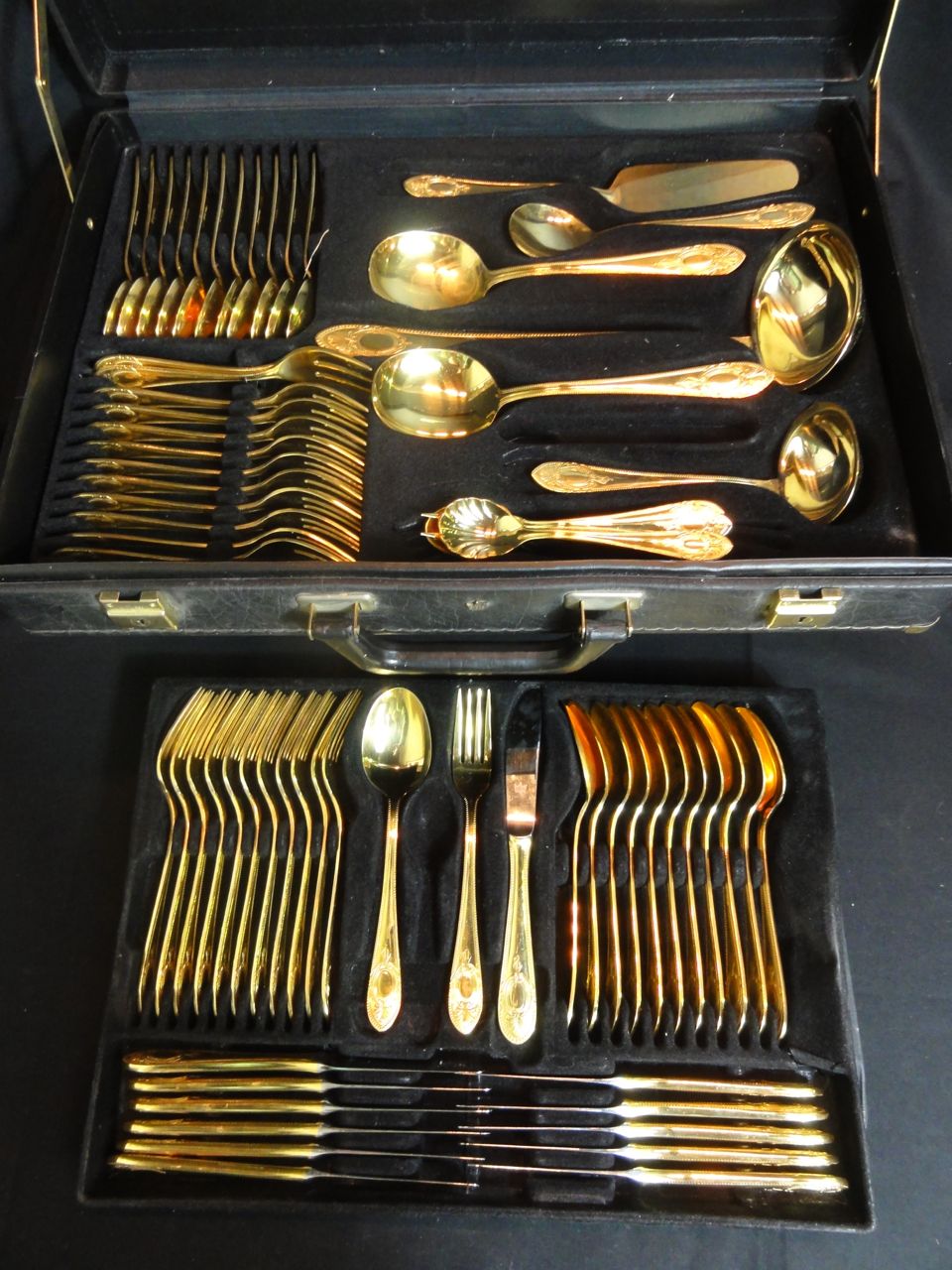 A cased twelve place 24 carat gold plated dinner service