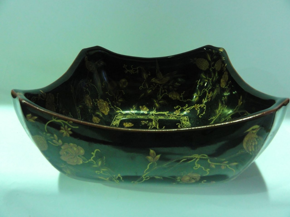 A cased Chinese bowl of square form with re-entrant corners decorated with birds amongst foliage and