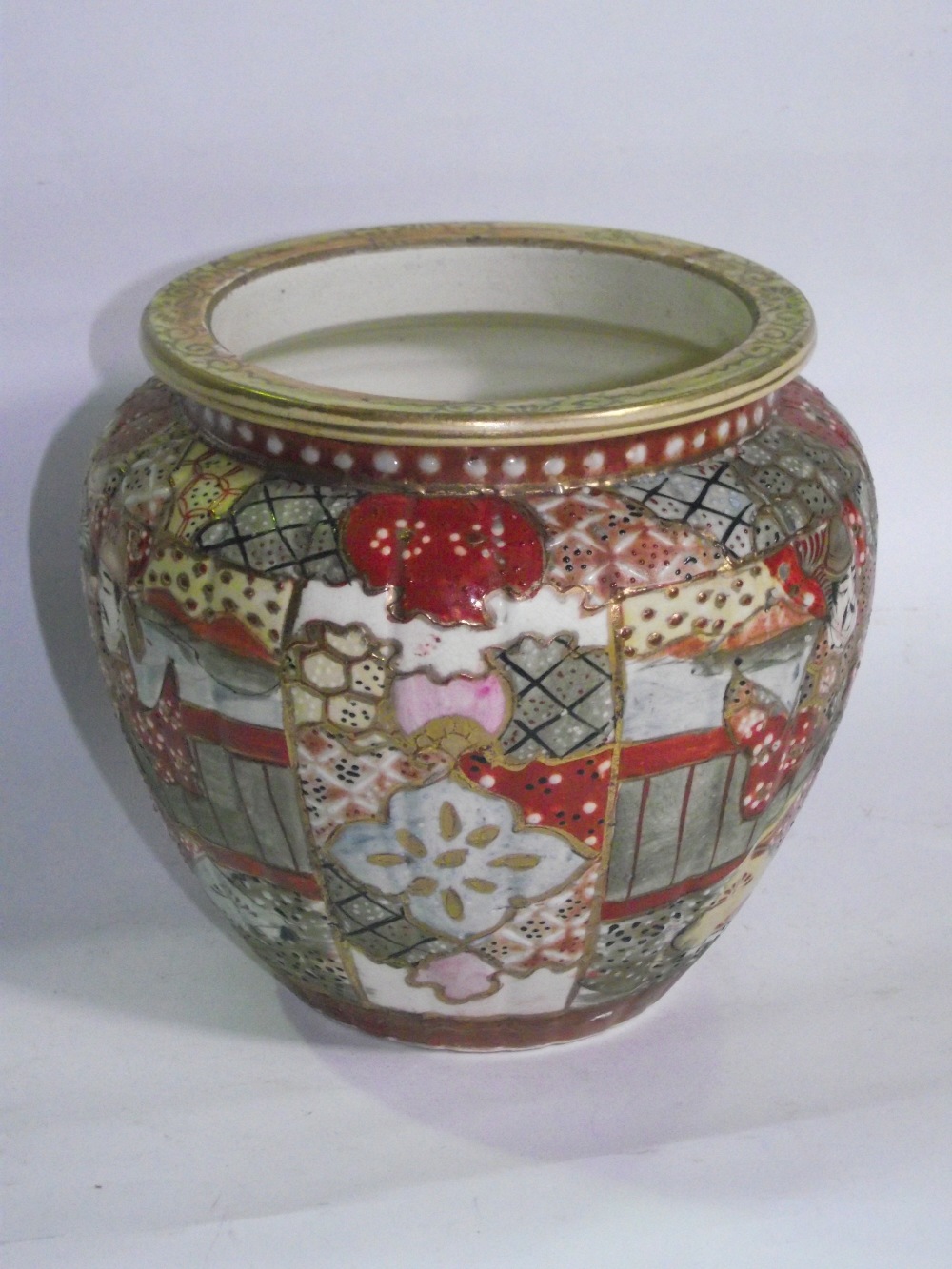 A Japanese earthenware Satsuma pattern shouldered vase of lobed form with iron red marks to base