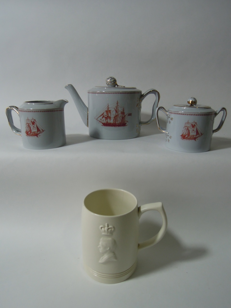 A Spode "Trade Winds" pattern three piece tea set decorated with the ship "Friendship of Salem"