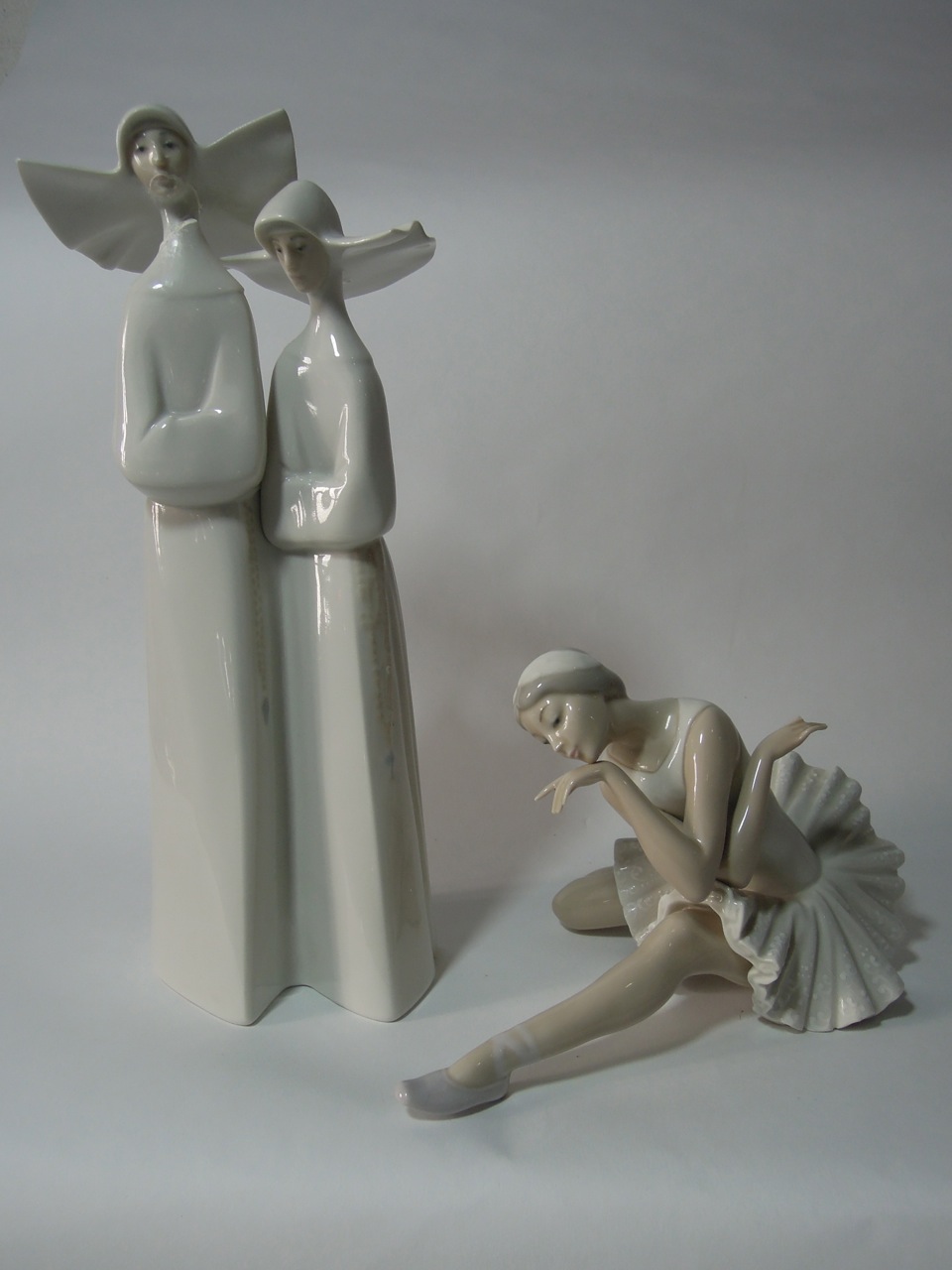 A Lladro nun group together with a Lladro ballet dancer