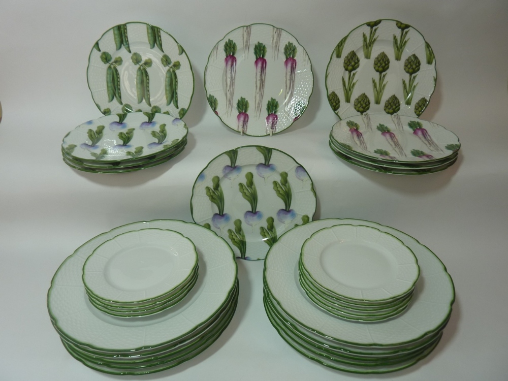 A selection of ten Limoges "Jardins de Villandry" plates of shaped form with basket weave borders