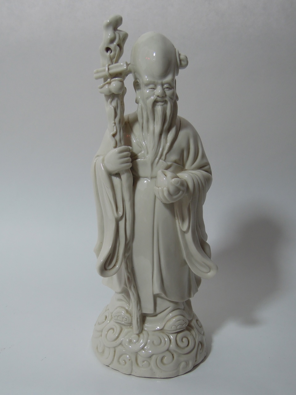 A 20th century Chinese figure of Shou-lao, the ancient Chinese Taoist God of long life and luck,