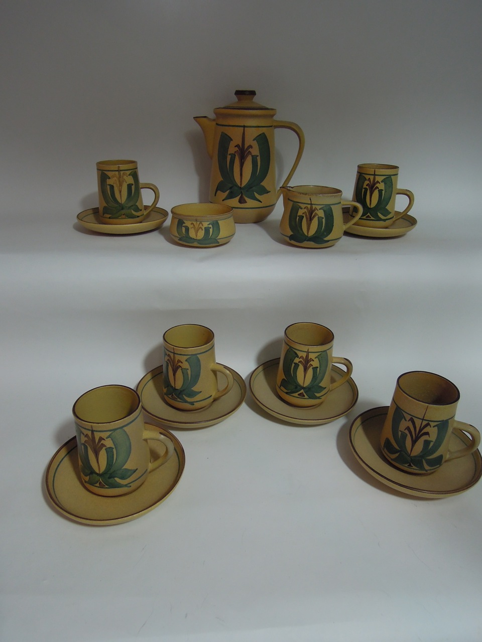 A Honiton Pottery coffee set comprising coffee pot, cream jug, sugar bowl and six cups and