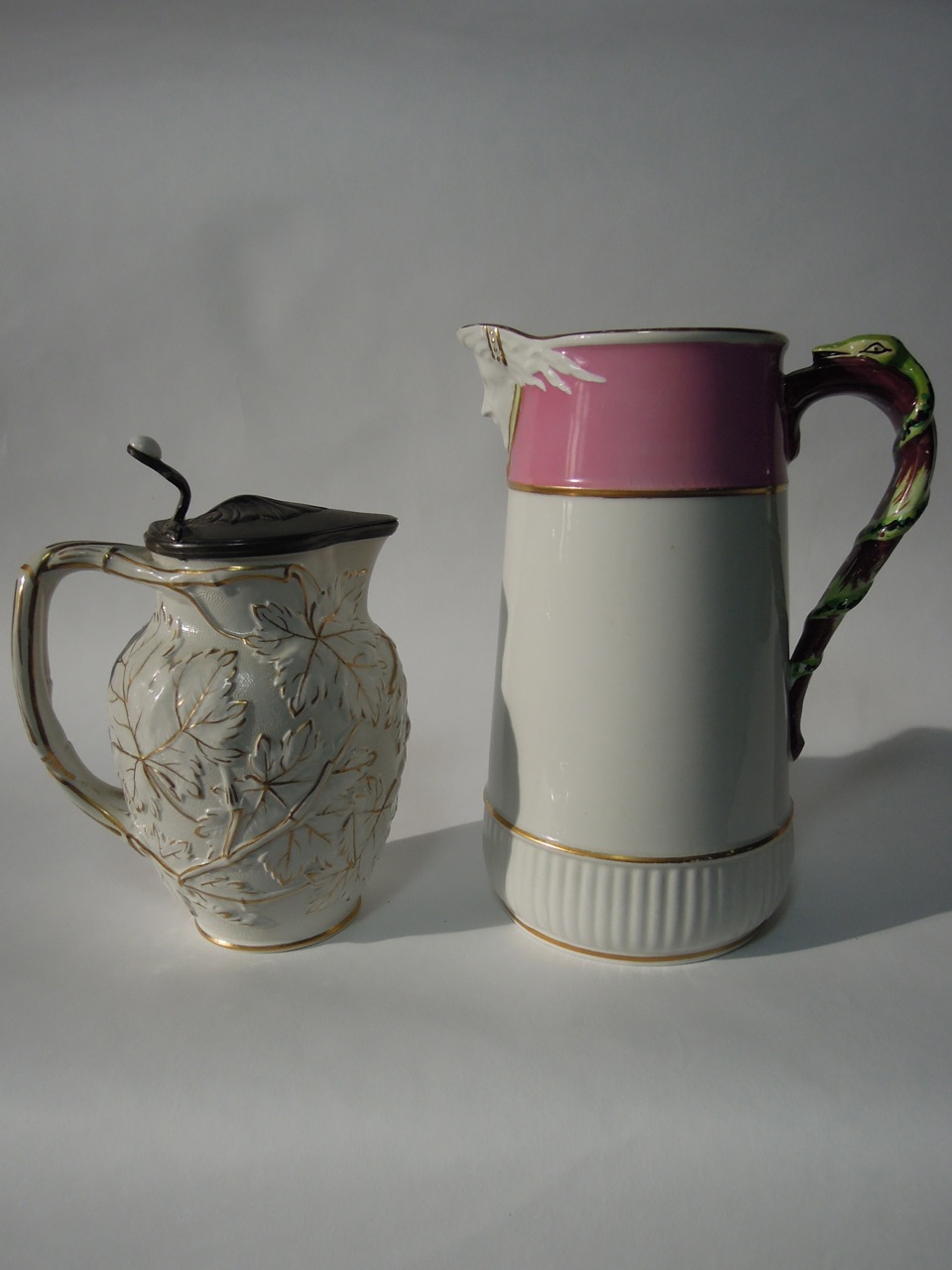 A pink and white Victorian jug by Edwards D H, with mask head spout and snake handle together with a