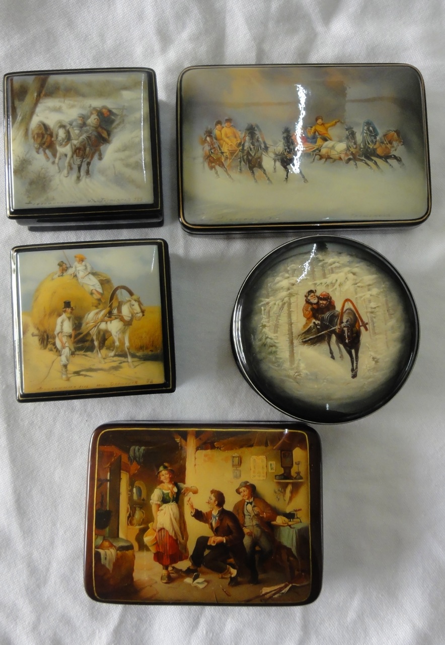 A collection of five Russian lacquered trinket boxes with genre scene decorations including Troika -