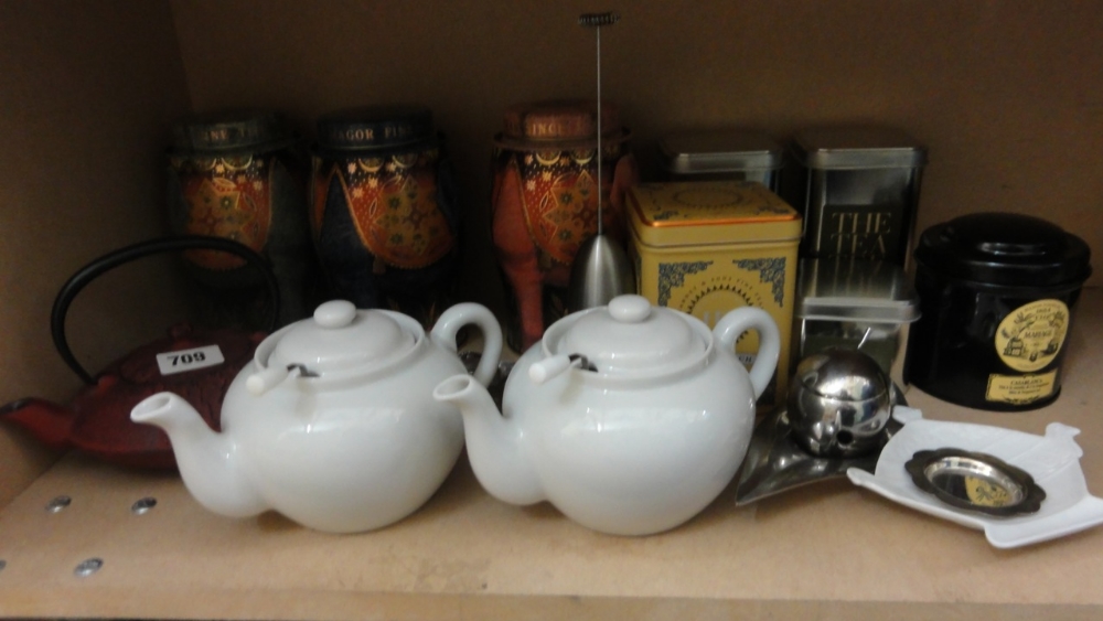 A quantity of tea related items including a pair of white glazed teapots and strainers, various