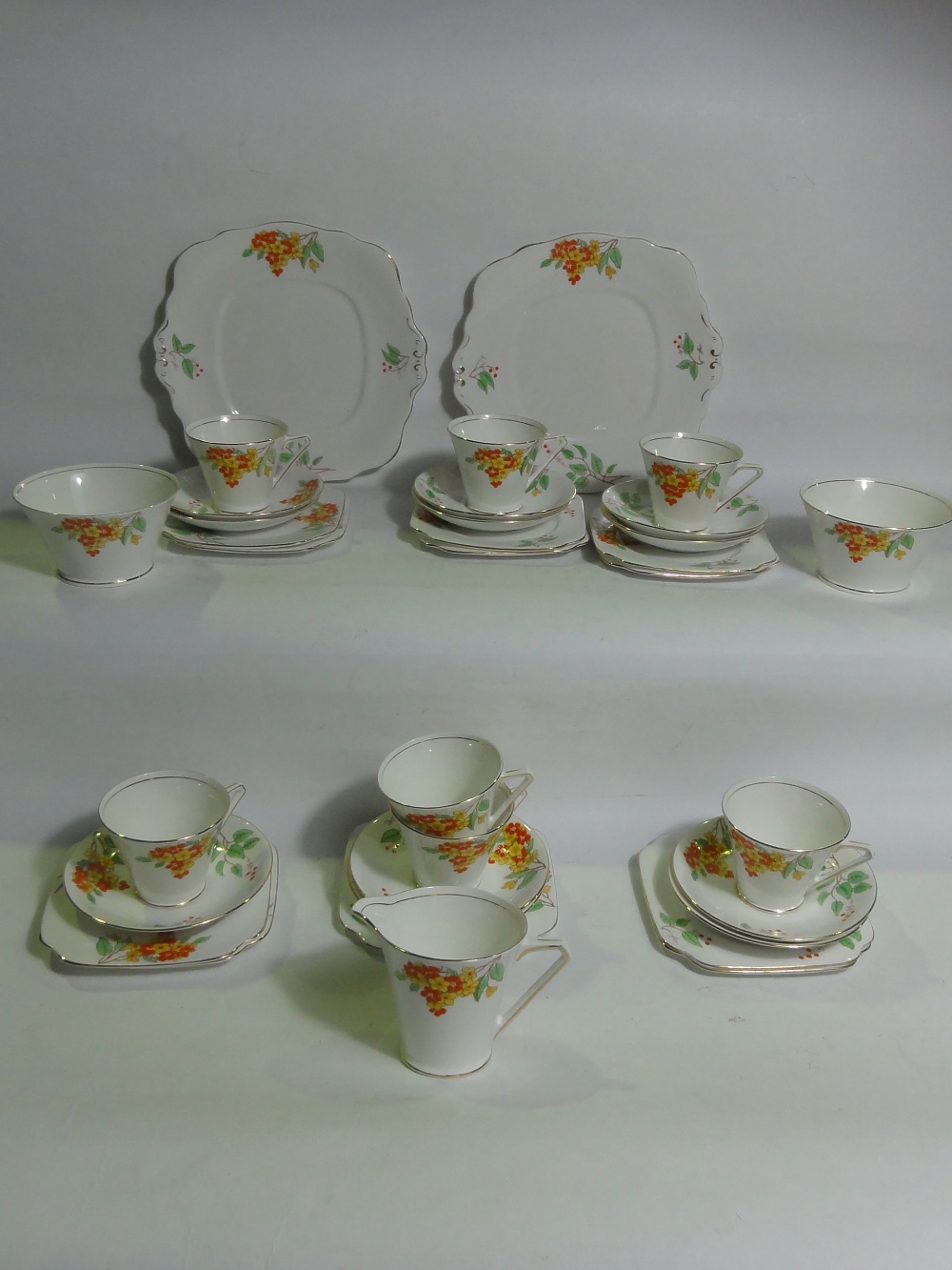 A collection of Art Deco style Bell China 3481 tea wares comprising seven cups, eleven saucers and
