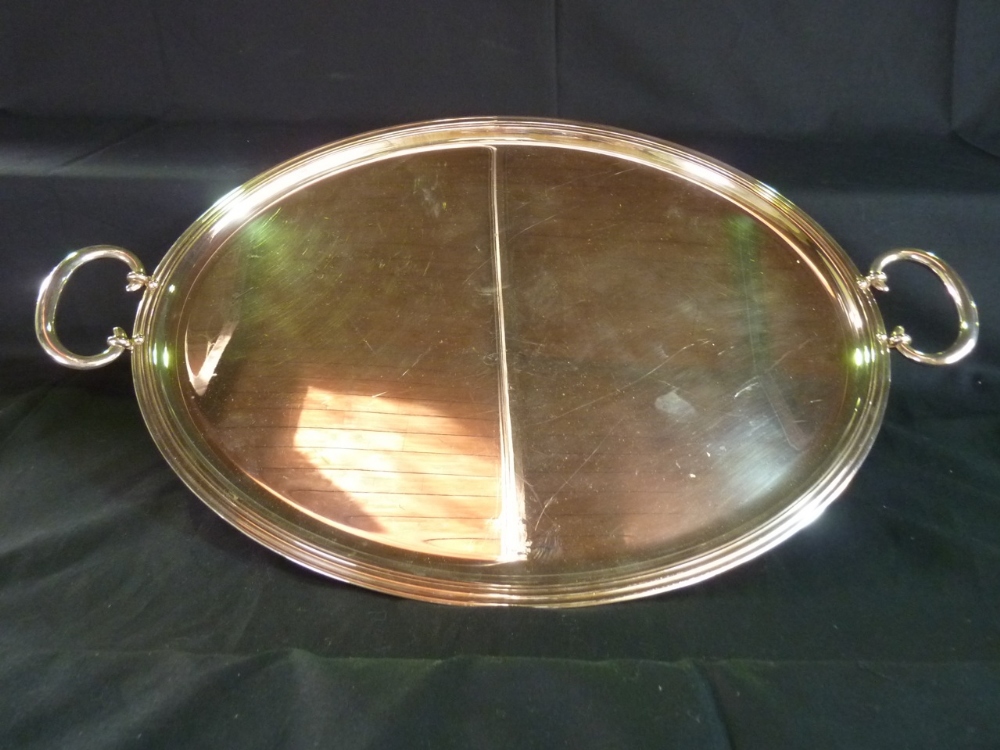 A substantial Christofle France two handled oval serving tray with reeded border