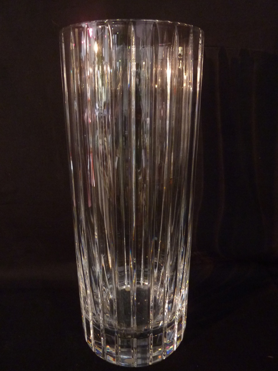 A tall crystal vase by Baccarat of rounded form with vertical cut decoration, 30cm tall approx