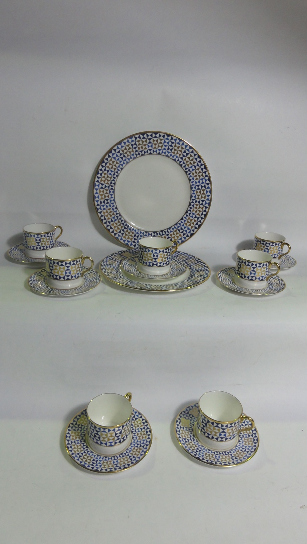 A quantity of traditional arts "Elementa" blue and gold geometric pattern coffee cans and saucers (