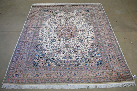 AN INDO- PERSIAN CARPET, MODERN the ivory field with a walnut floral medallion and spandrels all