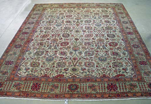 A TABRIZ CARPET, NORTH WEST PERSIA, CIRCA 1970 the ivory field with an overall design of