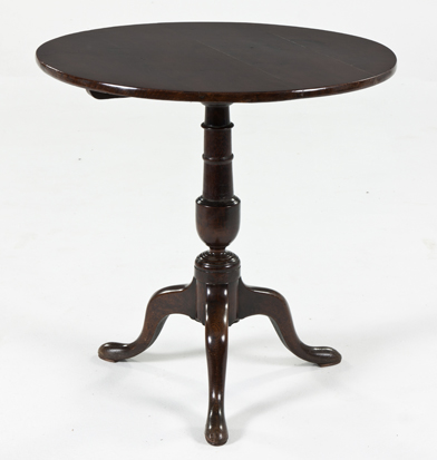 A GEORGE III OAK TILT-TOP TRIPOD TABLE the hinged circular top above a turned support, on hipped