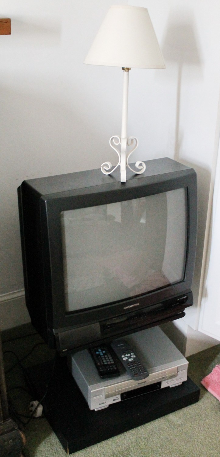 Grundig television, Toshiba VHS player and a wrought iron table lamp.  (4)