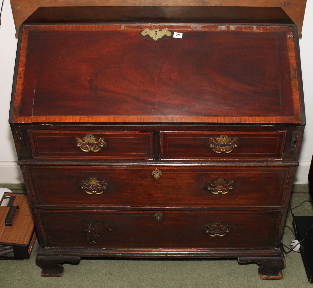 Georgian mahogany and crossbanded bureau with two short over two long graduated drawers raised on