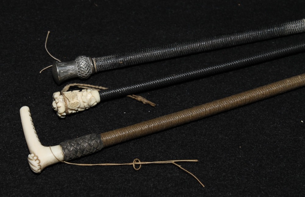 Carved bone-mounted riding crop, another with silver metal thistle head finial, and another with