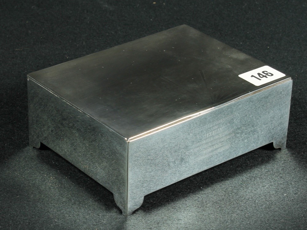 Silver cigarette box, the flat lid with engine-turned sunburst decoration.