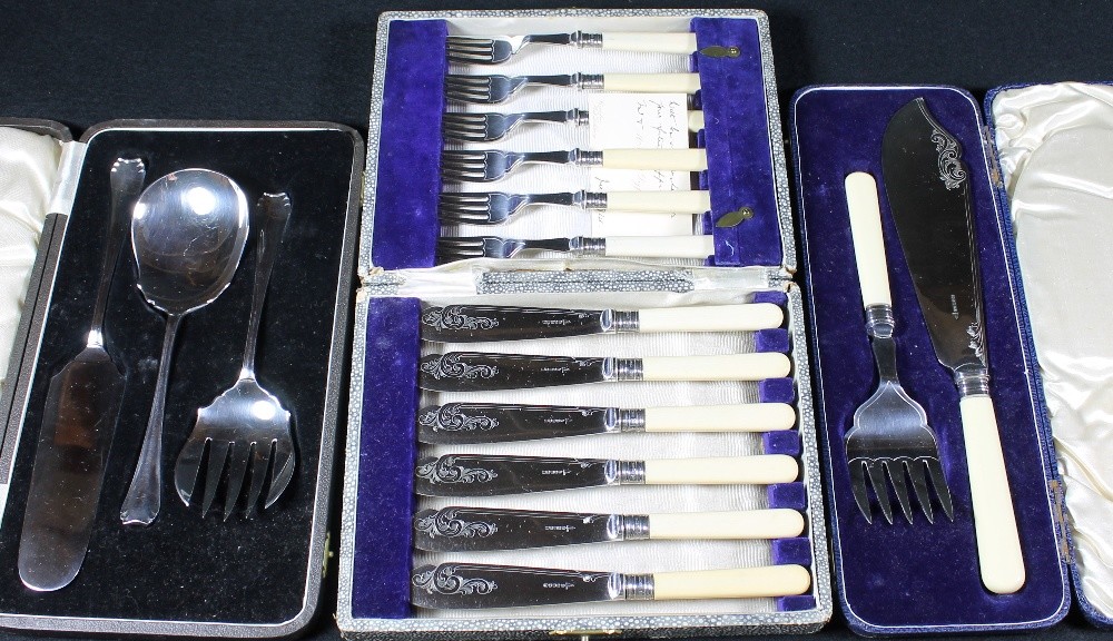 Set of six fish knives and six forks, a pair of fish servers, and a set of three servers, all cased,