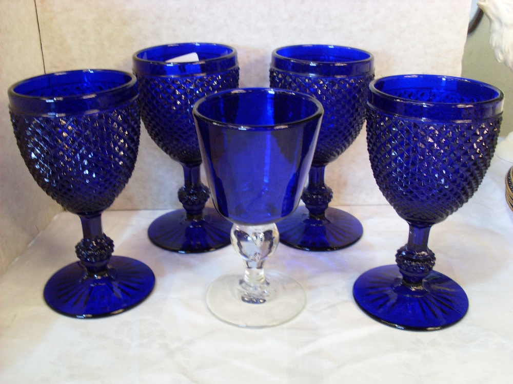 Four blue glass goblets and another.