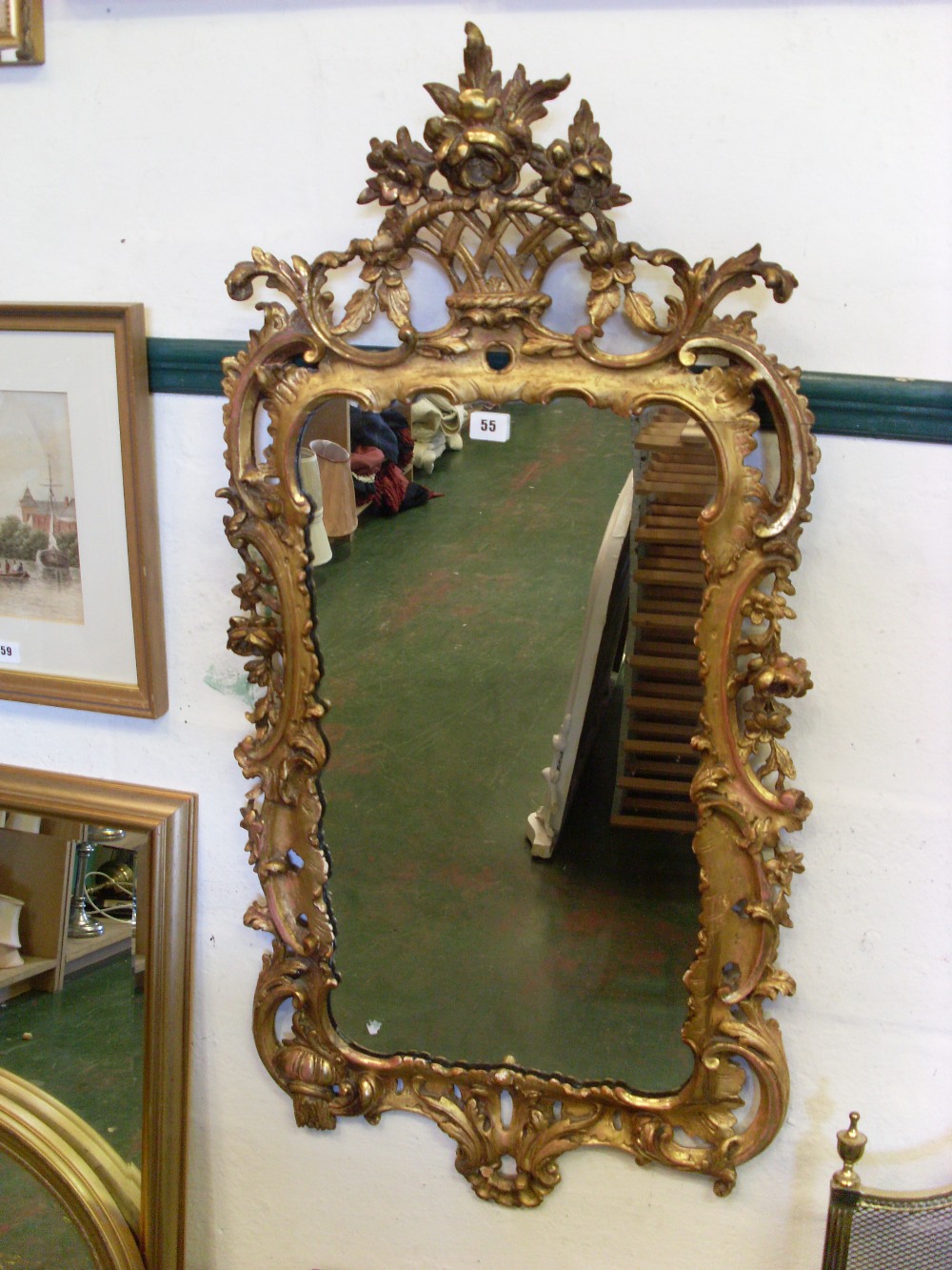 Edwardian giltwood mirror, the oval plate in a naturalistic vine leaf surround, the cresting