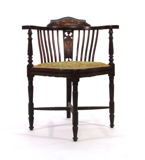 An Edwardian mahogany strung and inlaid corner armchair on turned legs