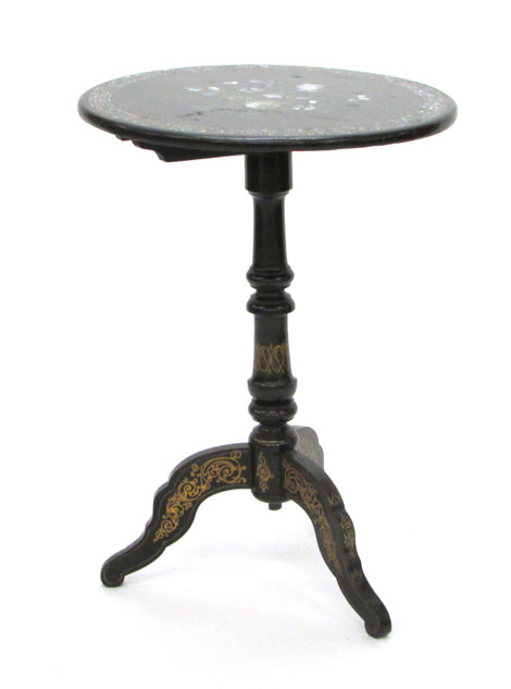 A Victorian black japanned wine table with mother of pearl inlaid and gilt decoration on a tripod