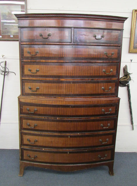 An early 19th century 'fiddle back' mahogany, crossbanded and strung chest on chest of bow fronted
