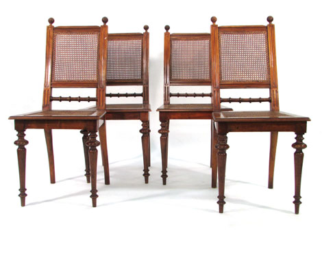 A set of four late 19th century walnut and caned dining chairs on turned tapered legs CONDITION