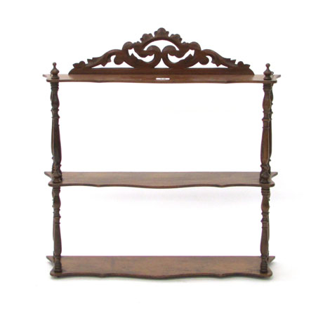 A Victorian walnut set of three hanging wall shelves of serpentine form, w. 60 cm CONDITION