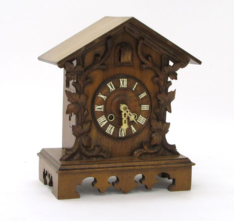 A Black Forest walnut cased bracket clock, the moulded dial with ivorine numerals supporting a