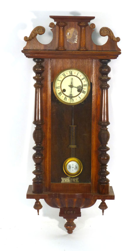 A Vienna Regulator-type wall clock with ivorine dial in a beech wood case of architectural form,