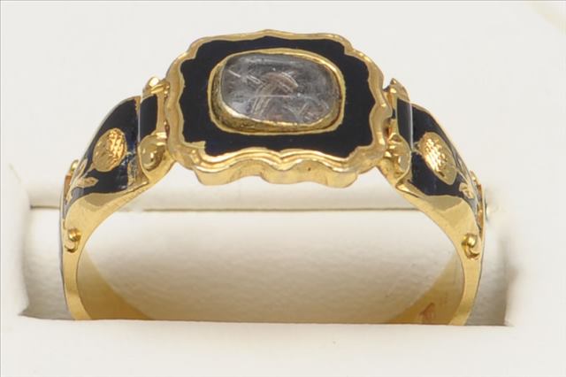 A FINE VICTORIAN 18CT GOLD AND BLACK ENAMEL MEMORIAL RING LONDON 1848. Central locket of hair within