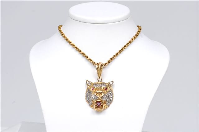 AN UNHALLMARKED, UNUSUAL ELABORATE DIAMOND AND RUBY TIGERS HEAD PENDANT, of foreign extract with