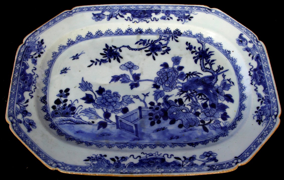 A Chinese porcelain meat plate painted in underglaze blue with a garden scene, Qianlong period,